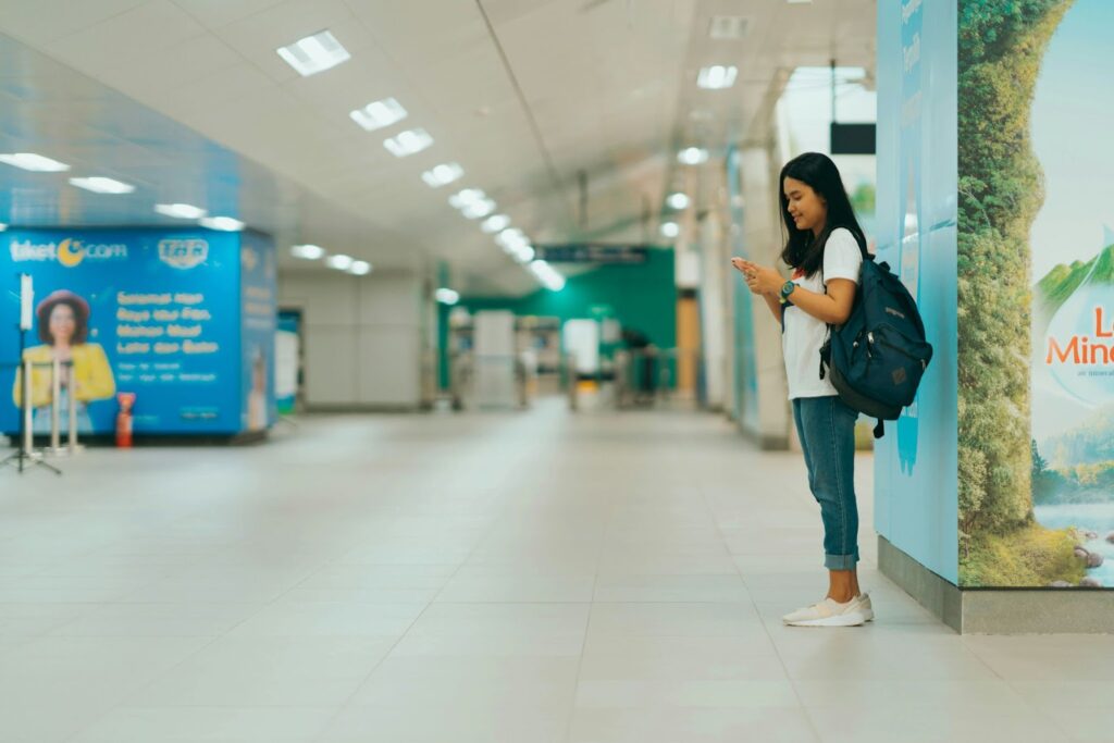 Girl standing next to a wall in the airport